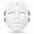 Front view of the Red Light Therapy Mask showing its white contoured shell, touch-control symbol and grey fastening straps