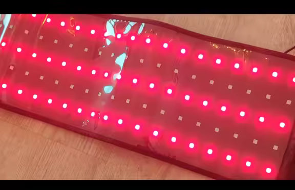 Product photo: the Large Red Light Therapy Body Wrap opened out with its red light panel illuminated.