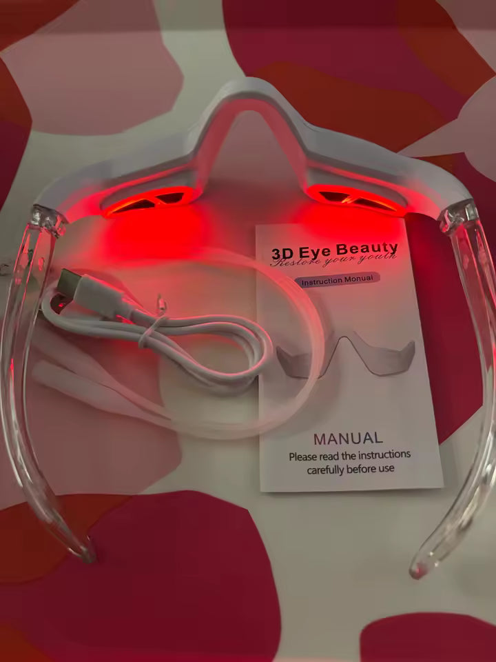 The Red Light Therapy Eye Mask photographed with its cable, packaging and illuminated inner lights.
