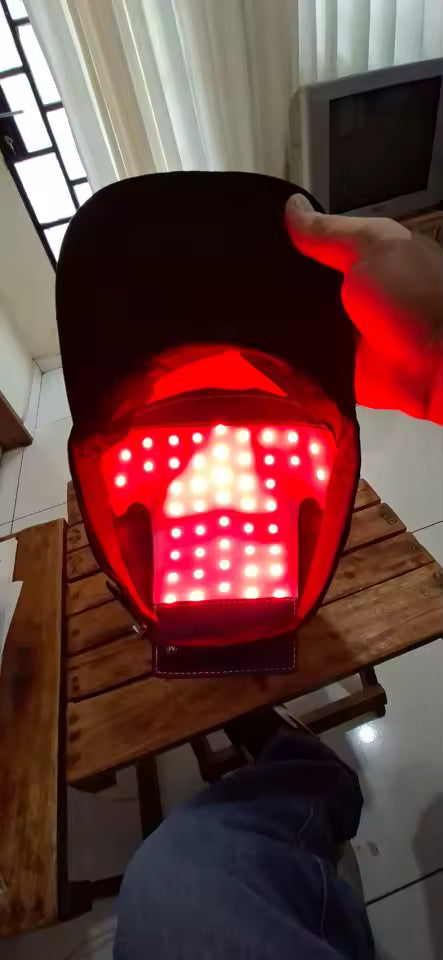 Product photo: the Red Light Therapy Hair Cap held open to show its inner light panel.