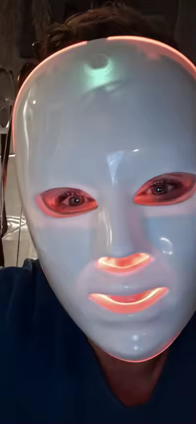Front view of a customer wearing the white Red Light Therapy Mask.