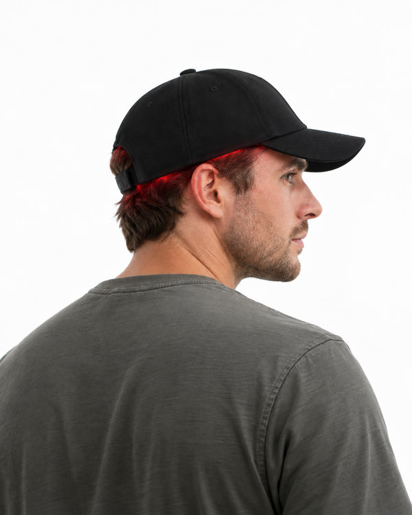 Man wearing a red light therapy cap